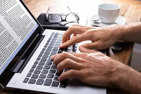 Typing with two hands on laptop